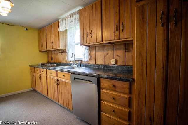 3118 W 104th St, Grant, MI 49327 - kitchen featuring dishwasher, a sink, dark countertops, brown cabinetry, and carpet floors