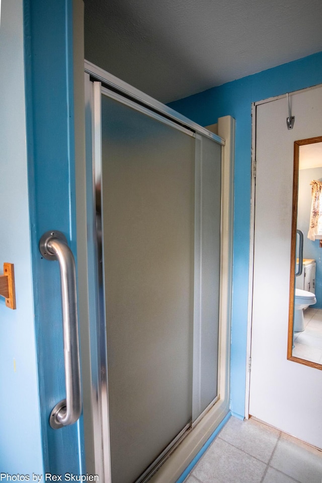 3118 W 104th St, Grant, MI 49327 - bathroom featuring a shower stall and tile patterned flooring