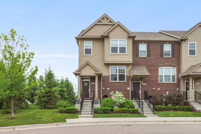 2605 Helmsdale Cir, Rochester, MI 48307 - multi unit property with brick siding, a front yard, and roof with shingles