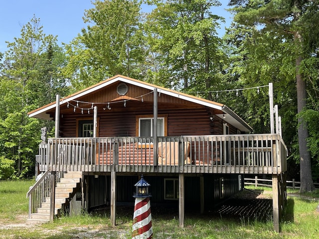 32480 W Old Chip Rd, Paradise, MI 49768 - log home featuring stairway, log siding, and a deck
