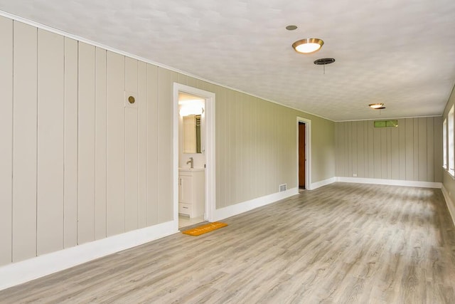 6604 E H Ave, Kalamazoo, MI 49048 - empty room with wood finished floors, ornamental molding, and baseboards