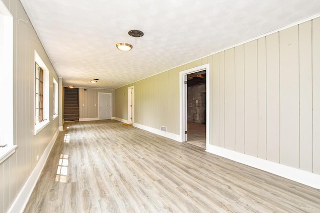 6604 E H Ave, Kalamazoo, MI 49048 - unfurnished room with stairs, light wood-style floors, and baseboards