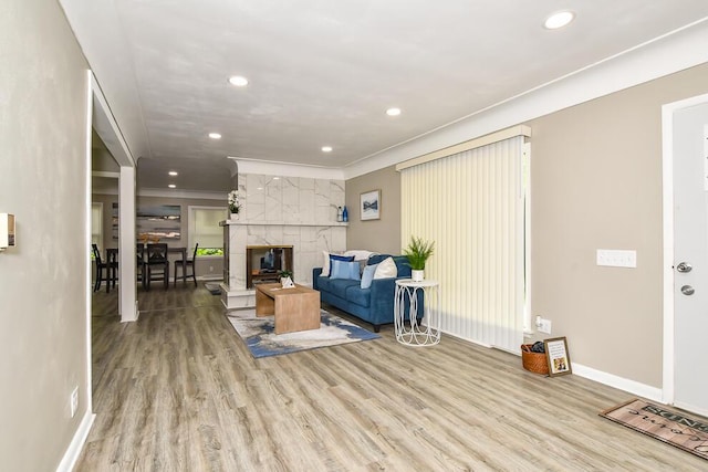 6604 E H Ave, Kalamazoo, MI 49048 - living area with recessed lighting, wood finished floors, baseboards, crown molding, and a tile fireplace