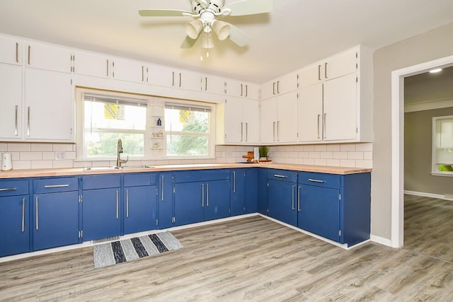 6604 E H Ave, Kalamazoo, MI 49048 - kitchen featuring blue cabinets, a sink, backsplash, and ceiling fan