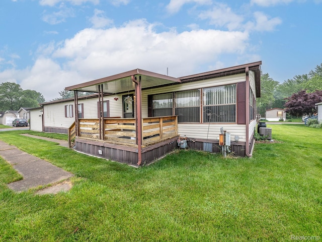 285 Heather, Temperance, MI 48182 - rear view of property featuring a lawn, central air condition unit, and covered porch