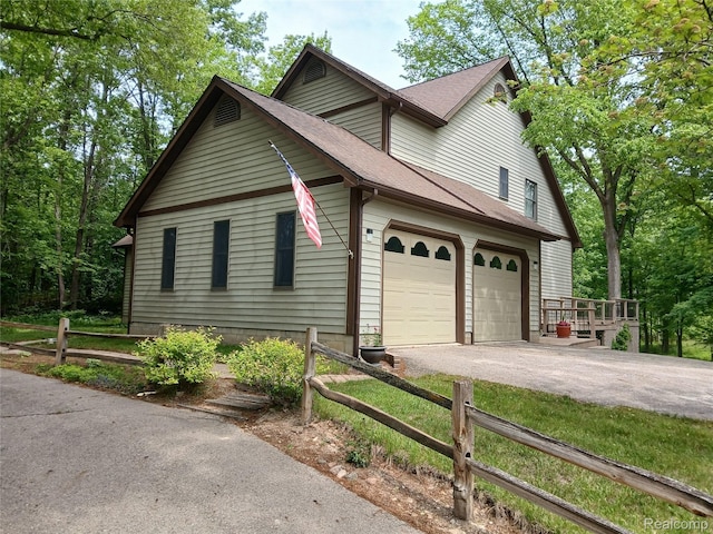 1455 Sand Rd, Port Austin, MI 48467 - view of side of home with a shingled roof, driveway, and a garage