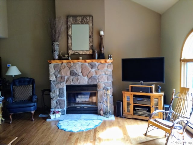 1455 Sand Rd, Port Austin, MI 48467 - living area with wood finished floors, lofted ceiling, and a stone fireplace