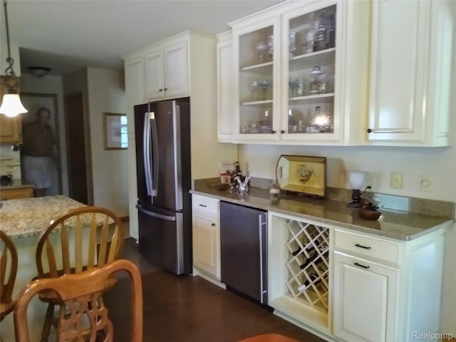 1455 Sand Rd, Port Austin, MI 48467 - kitchen with freestanding refrigerator, refrigerator, glass insert cabinets, and white cabinetry