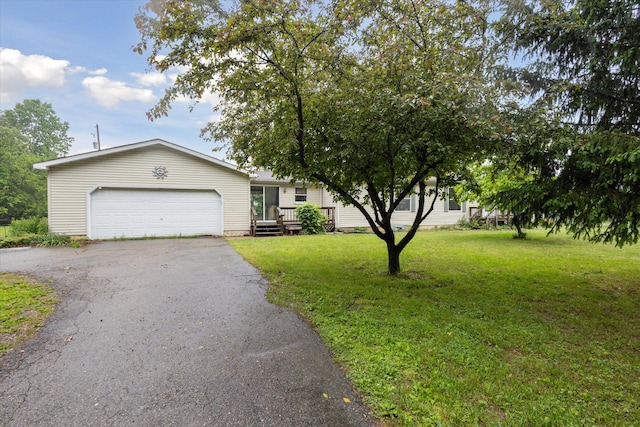 7100 Tripp Rd, Horton, MI 49246 - view of front facade featuring driveway, a front yard, and a garage