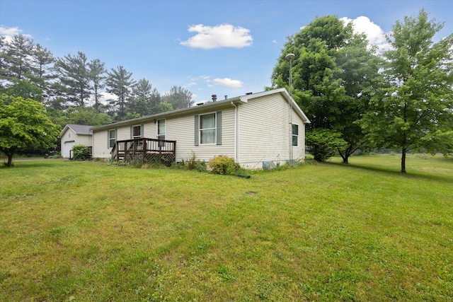 7100 Tripp Rd, Horton, MI 49246 - rear view of property with a wooden deck and a lawn