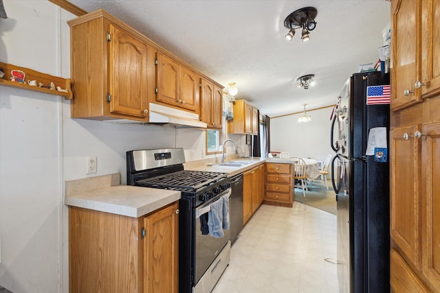 7100 Tripp Rd, Horton, MI 49246 - kitchen with stainless steel range with gas stovetop, freestanding refrigerator, under cabinet range hood, light floors, and dishwasher
