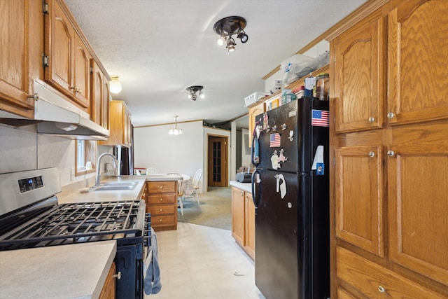 7100 Tripp Rd, Horton, MI 49246 - kitchen with freestanding refrigerator, gas stove, a sink, light flooring, and brown cabinetry