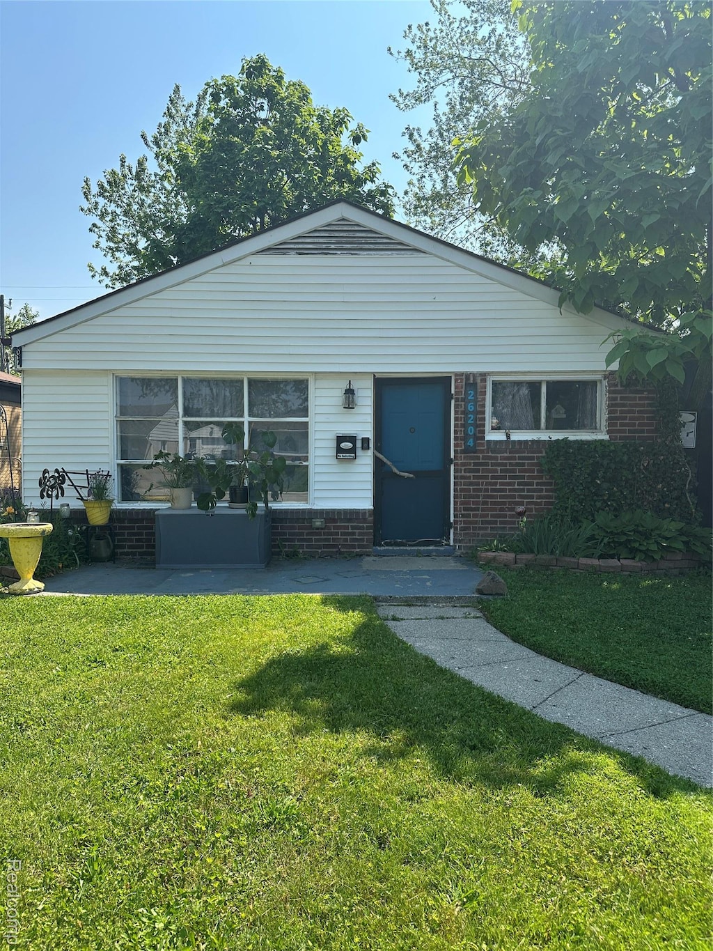 26204 Lehner St, Roseville, MI 48066 - view of front facade with a front lawn and brick siding
