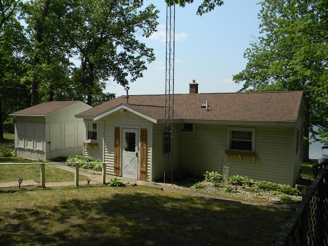 67 S Emerson Dr, Branch, MI 49402 - ranch-style home with a chimney, a shingled roof, and a front yard