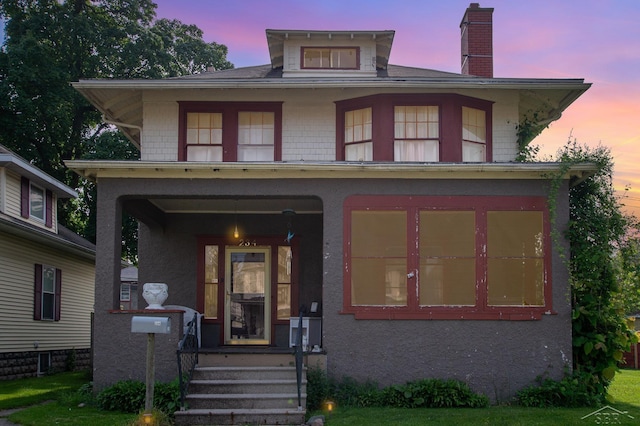 234 N Jackson St, Bay City, MI 48708 - american foursquare style home featuring a chimney and covered porch