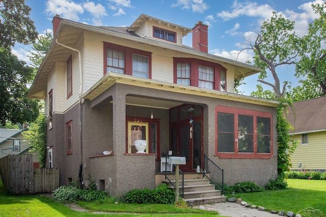 234 N Jackson St, Bay City, MI 48708 - american foursquare style home featuring a chimney and stucco siding