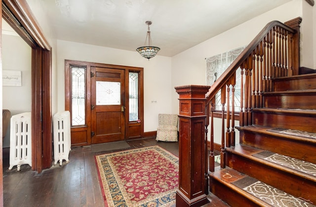 234 N Jackson St, Bay City, MI 48708 - entryway featuring radiator, dark wood finished floors, stairway, and healthy amount of natural light