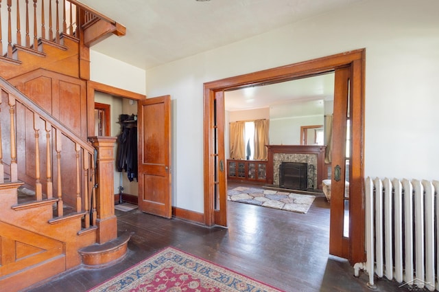 234 N Jackson St, Bay City, MI 48708 - foyer entrance featuring radiator heating unit, dark wood-style flooring, stairs, and baseboards