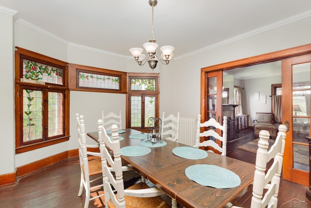 234 N Jackson St, Bay City, MI 48708 - dining room with radiator heating unit, wood-type flooring, crown molding, a chandelier, and baseboards