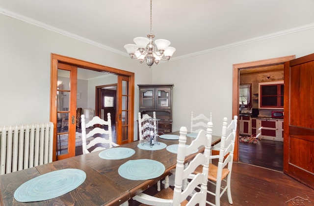 234 N Jackson St, Bay City, MI 48708 - dining room featuring radiator heating unit, crown molding, a chandelier, and wood finished floors