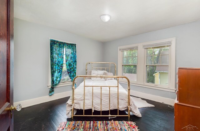 234 N Jackson St, Bay City, MI 48708 - bedroom featuring baseboards and hardwood / wood-style floors