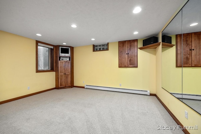 303 Stickney Ridge Rd, Grand Haven, MI 49417 - finished below grade area featuring a baseboard heating unit, light carpet, recessed lighting, and baseboards