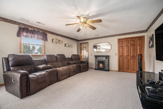 53029 Meadow View Ln, Paw Paw, MI 49079 - living room with carpet floors, ceiling fan, a stone fireplace, and baseboards