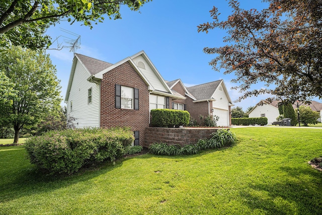 53029 Meadow View Ln, Paw Paw, MI 49079 - view of side of property with an attached garage, brick siding, and a lawn
