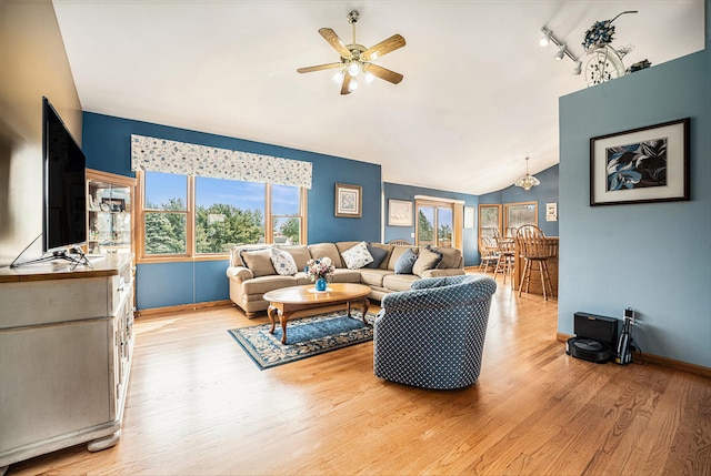 53029 Meadow View Ln, Paw Paw, MI 49079 - living area with vaulted ceiling, ceiling fan, light wood-type flooring, and baseboards