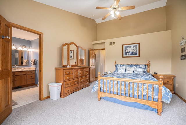 53029 Meadow View Ln, Paw Paw, MI 49079 - bedroom with light colored carpet, a sink, high vaulted ceiling, baseboards, and ensuite bath