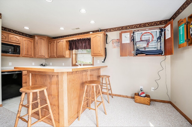 53029 Meadow View Ln, Paw Paw, MI 49079 - kitchen with black microwave, dishwasher, a kitchen breakfast bar, baseboards, and recessed lighting