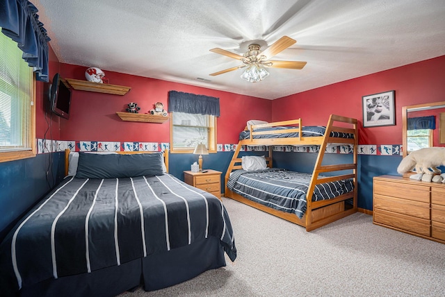 53029 Meadow View Ln, Paw Paw, MI 49079 - bedroom featuring multiple windows, carpet flooring, a ceiling fan, and a textured ceiling