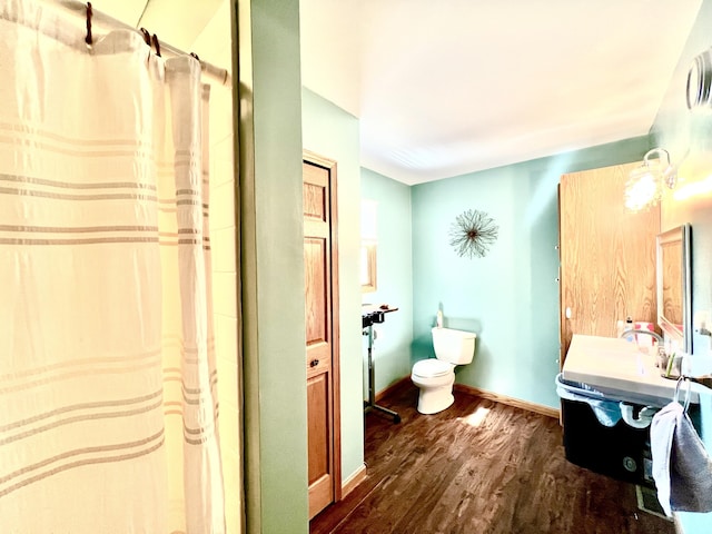 5781 S Waldron Rd, Pittsford, MI 49271 - full bath with wood finished floors, vanity, a shower with curtain, toilet, and baseboards