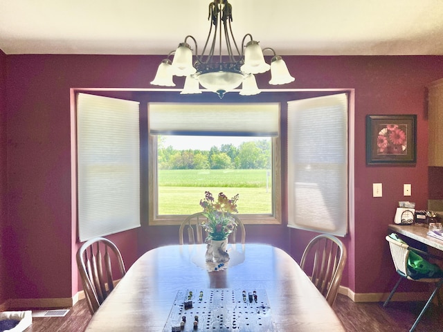 5781 S Waldron Rd, Pittsford, MI 49271 - dining room featuring a chandelier, baseboards, and dark wood-type flooring