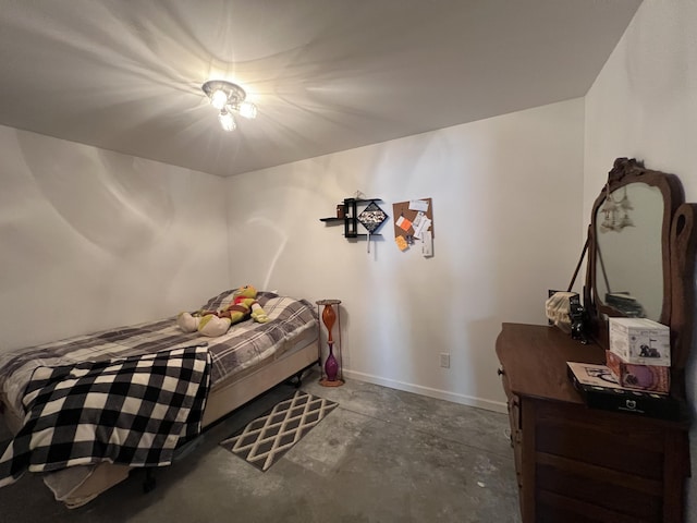 5781 S Waldron Rd, Pittsford, MI 49271 - bedroom featuring baseboards and unfinished concrete floors