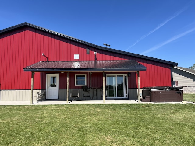 5781 S Waldron Rd, Pittsford, MI 49271 - back of house with a hot tub, a patio area, a yard, and metal roof