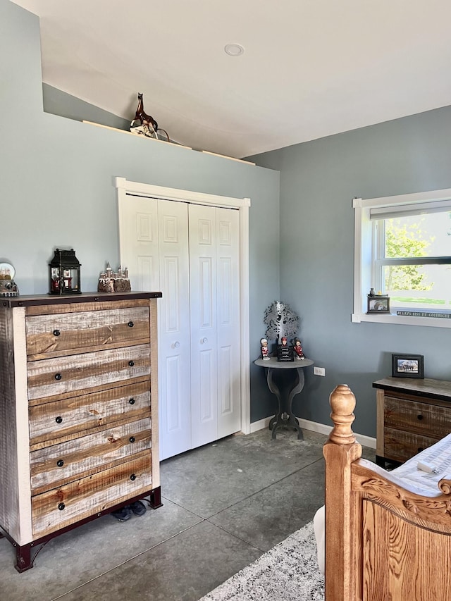 5781 S Waldron Rd, Pittsford, MI 49271 - bedroom featuring concrete floors, a closet, and baseboards