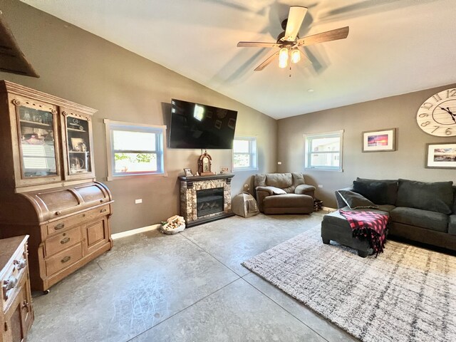 5781 S Waldron Rd, Pittsford, MI 49271 - living room featuring baseboards, concrete flooring, a ceiling fan, lofted ceiling, and a fireplace