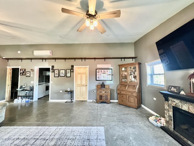 5781 S Waldron Rd, Pittsford, MI 49271 - living room featuring an AC wall unit, ceiling fan, baseboards, a stone fireplace, and concrete floors