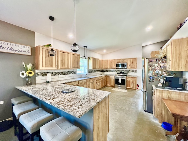 5781 S Waldron Rd, Pittsford, MI 49271 - kitchen with appliances with stainless steel finishes, a sink, a peninsula, lofted ceiling, and decorative backsplash