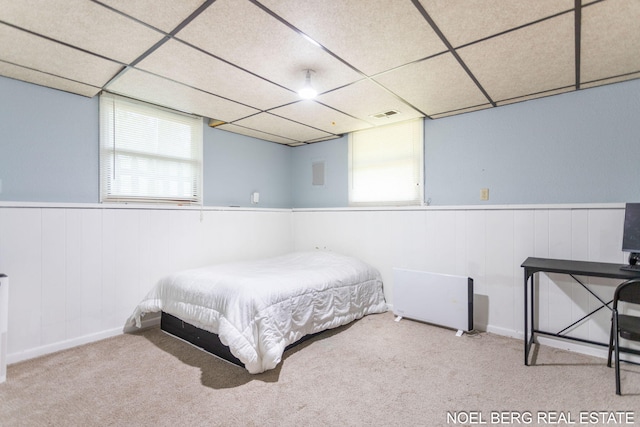1710 Dykhouse Ave, Grand Haven, MI 49417 - bedroom with carpet, a wainscoted wall, multiple windows, and a drop ceiling