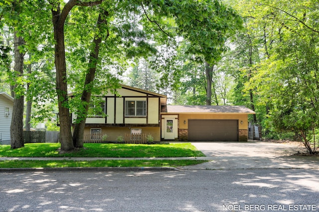 1710 Dykhouse Ave, Grand Haven, MI 49417 - tri-level home with a garage, brick siding, and concrete driveway