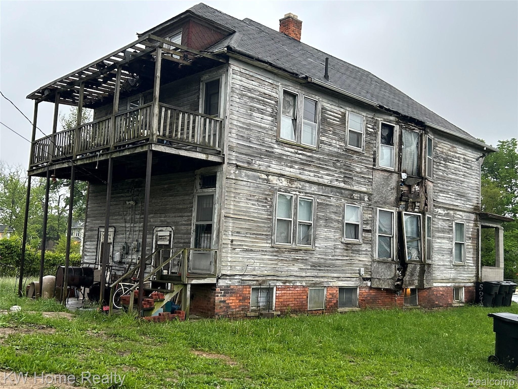 5102 Parker St, Detroit, MI 48213 - view of side of property with a lawn, a chimney, and a balcony