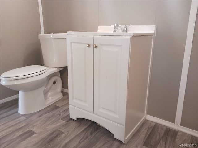 11132 Cape Cod St, Taylor, MI 48180 - bathroom with toilet, vanity, baseboards, and wood finished floors