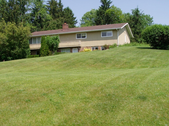 1358 Arroyo Dr, Ypsilanti, MI 48197 - back of house with a chimney and a yard
