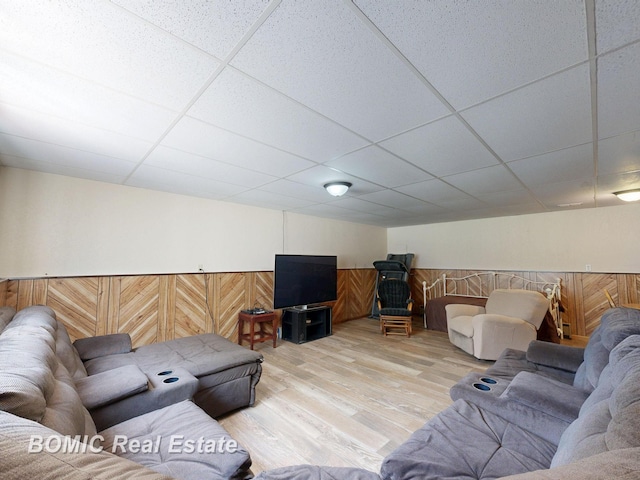 5612 Jay Rd, Vassar, MI 48768 - living room featuring a paneled ceiling, wood finished floors, a wainscoted wall, and wood walls
