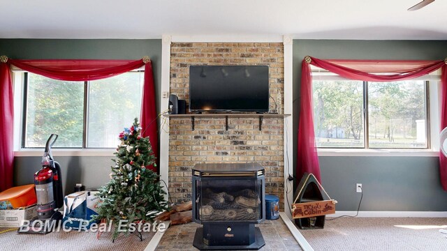 2081 Skiles Dr, Saint Helen, MI 48656 - carpeted living area with a fireplace and baseboards