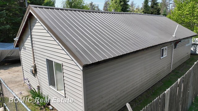 2081 Skiles Dr, Saint Helen, MI 48656 - view of side of home featuring metal roof
