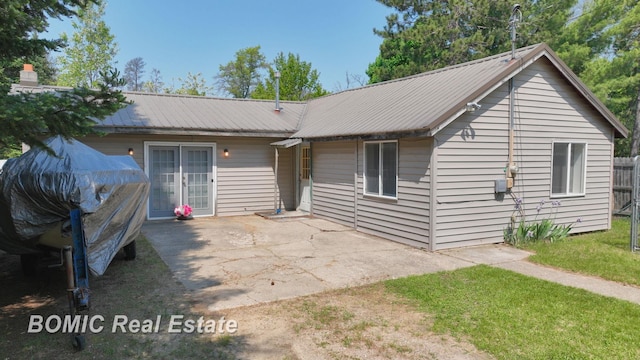 2081 Skiles Dr, Saint Helen, MI 48656 - rear view of property featuring metal roof and a patio