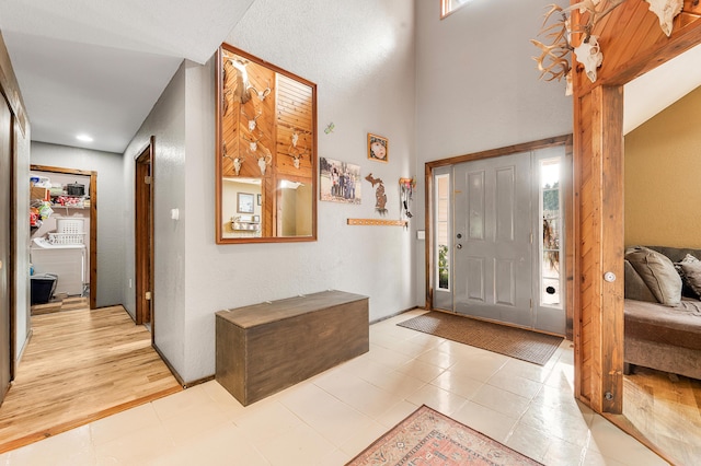 22251 210th Ave, Tustin, MI 49688 - entrance foyer with light tile patterned flooring and a high ceiling